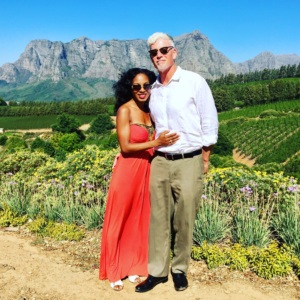 Interracial couple standing in a vineyard