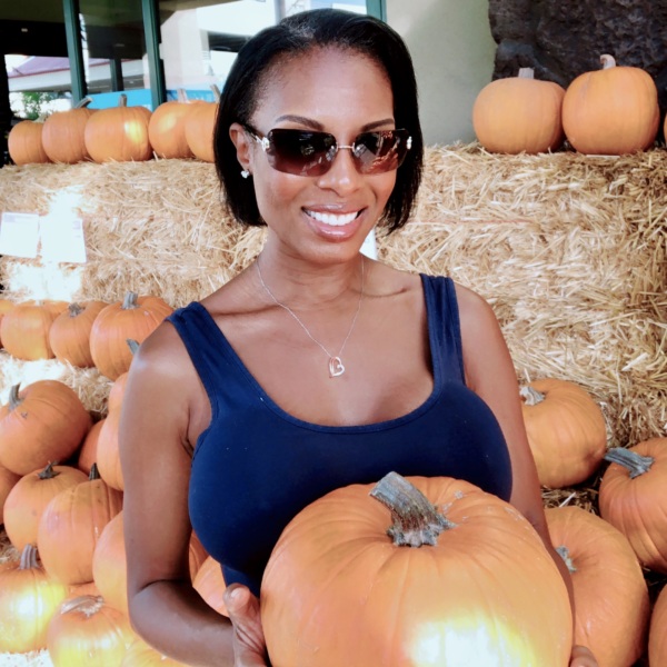Collette Gee at a pumpkin patch celebrating fall, seasonal love tips, and relationship goals.